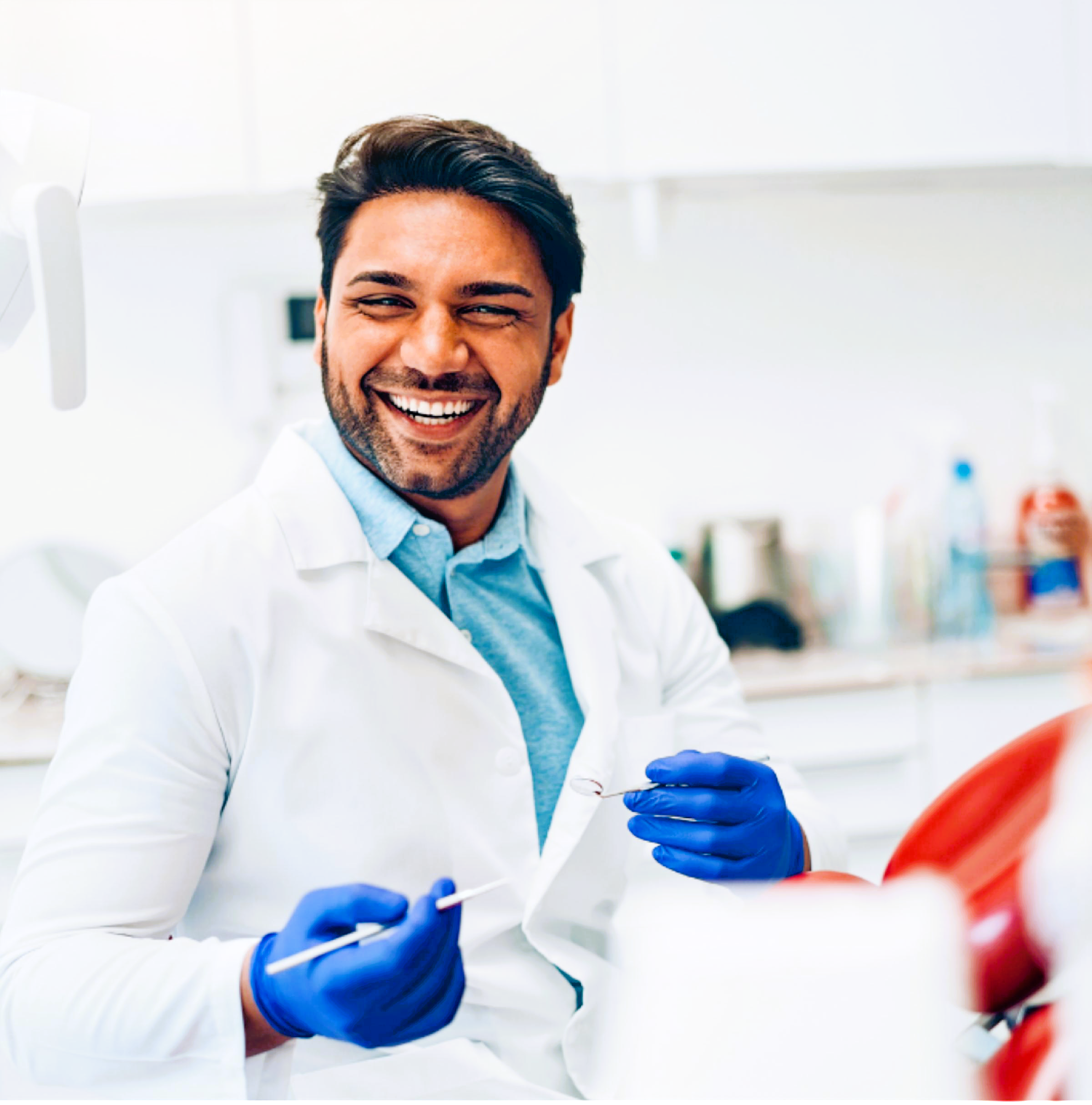 Dentist in a white coat smiling